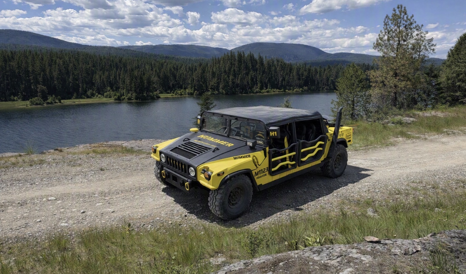 Yellow Humbee Humvee parked above Upper Stillwater lake in the Montana backcountry